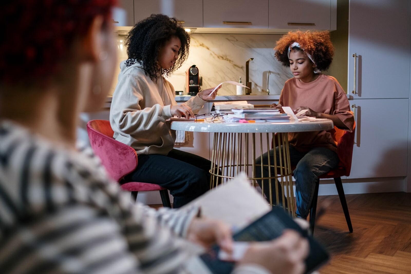 Women working together at a table in a shared apartment